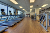 Fitness room with treadmills, and other cardio equipment and weights.