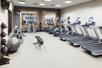 Fitness center with plenty of gym equipment.