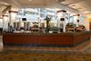 A breakfast buffet bar with several different food options in the lobby of the Embassy Suites by Hilton Portland Airport.