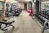 Fitness center equipped with cardio equipment on the left and weights on the right at the Embassy Suites by Hilton Portland Downtown.