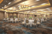 Meeting/Banquet facility with tables, chairs and carpeted floors.