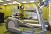 Fitness room with treadmills, and other cardio equipment, and weights.