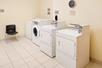 Guest laundry with washing machine and dryers.