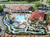 Aerial view of the resort's pool area and lazy river and water slide.