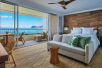 Guest room with one king bed, sofa bed, and private balcony with ocean view.