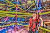 A child does the indoor rope climbing course