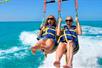 Two women as they take off to parasail on the Fury Water Adventure Parasailing in Key West, Florida.