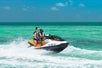 Two riders jet skiing over the waves on the Fury Water Adventure Ultimate Jet Ski Tour of Key West.