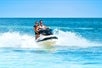 A couple riding a Jet ski on the Fury Water Adventure Ultimate Jet Ski Tour of Key West.