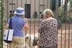 Tour guide stops with a guest to visit a dog