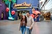 A couple taking a picture at the entrance of Freemont Street with Las Vegas Downtown - Fremont St. Walking Tour.
