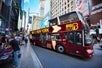 A red double decker bus by Big Bus New York in the street of Manhattan with Go City New York Explorer Pass.