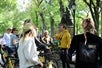 A group of cyclists gathers around a tour guide at Central Park Sightseeing Bike Tours and Rentals, listening attentively to the guide's instructions.