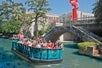 A group of tourists enjoying the Go Rio San Antonio River Cruise ride with Go San Antonio Explorer Pass.
