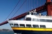 People aboard the boat named "Old Blue" while crossing under the Golden Gate Bridge with Go San Francisco Explorer Pass.