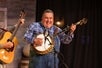 Goldwing Express band member picking his banjo on the Playhouse Theater stage at Shepherd of the Hills.