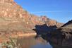 View of the famous rock formations of Grand Canyon with a shadow being cast across part of them on a sunny day.
