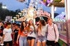 A group of friends walk through the dazzling lights at the carnival in Grapevine, TX
