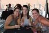 Three women sip champagne on the Champagne Terrace