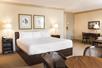 A guest room with one king bed, a coffee table, and a work desk, combining comfort and convenience.