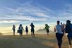 A group of hikers following their tour guide on a rocky area on the Griffith Park Experience: Hollywood Hills Hike.