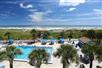 Aerial view of the outdoor pool and pool bar, and the walk way to the beach at Guy Harvey Resort in St. Augustine, FL.