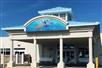 Front entrance to the hotel with Guy Harvey's signed painting of three dolphins and a turtle.