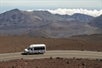 The tour van as it passes by the crater on the Haleakala Sunrise Tour in Wailuku Hawaii, USA.