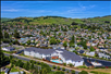 Aerial view of the hotel and the hills in the background.