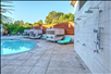 Outdoor pool with day beds and open shower area.