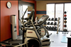 Fitness center equipped with cardiovascular equipment and free weights.