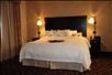 One king bed with plush beddings inside a guest room.