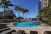Outdoor pool with sun loungers at Hampton Inn Cocoa Beach, Florida.
