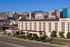 The beautifully landscaped exterior of the Hampton Inn Salt Lake City Downtown on a bright and sunny day.