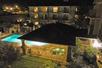 View looking down on the outdoor pool and hot tub at the Hampton Inn Ukiah at night.