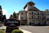 View of the exterior of the Hampton Inn Ukiah on a bright sunny day in Asheville, North Carolina.