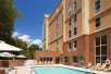 Outdoor pool with sun loungers at Hampton Inn & Suites Charlotte-Arrowood Rd., NC.