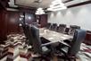 Conference room with black leather executive chairs.
