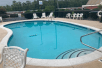 Outdoor pool with sun loungers at Hampton Inn Hot Springs.