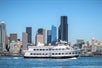 Argosy cruise ship as it passes in front of the city, specifically Smith Tower. Harbor Cruise Seattle Washington.
