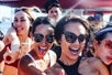 A group of girls posing cheerfully on the Hawaii Glass Bottom Boat Tour in Honolulu, Hawaii.