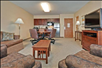 Living area with a comfortable sofa, TV, and dining table, plus a kitchen for your convenience.