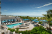 View of the outdoor pool with sun loungers at Hilton Garden Inn Cocoa Beach-Oceanfront, FL.