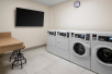 Guest laundry area with dryers and washers.