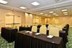 A conference room with rows of black cloth covered tables with beige chairs at the Hilton Garden Inn International Drive North in Orlando, Florida