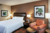 1 King-sized luxurious Suite Dreams® by Serta bed and seating area at Hilton Garden Inn Seattle Downtown.