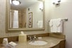 Private bathroom with fresh towels, bath amenities, and a vanity area.