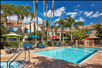 Refreshing outdoor pool and hot tub with sun loungers.