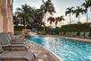 Outdoor pool with sun loungers at Hilton Naples, FL.