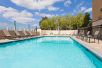 Outdoor pool with sun loungers at Holiday Inn Diamond Bar - Pomona, an IHG Hotel, CA.